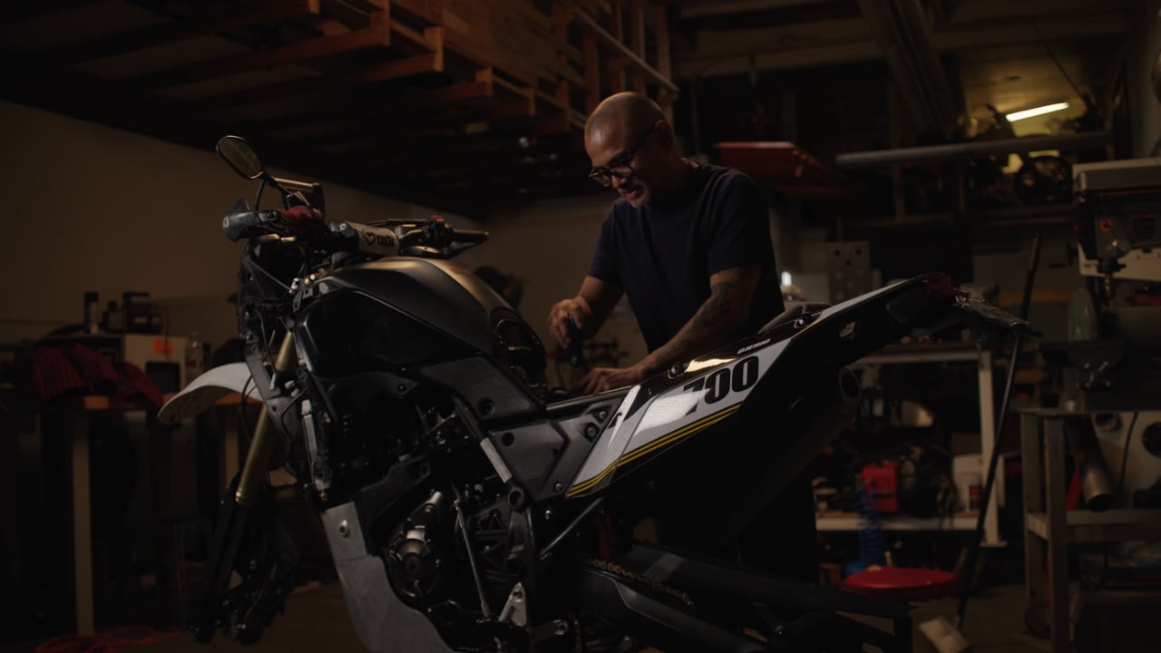 Noel stripping down his dirt bike in the shop before the Biltwell 100